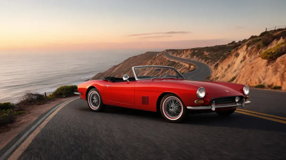 The same convertible on a coastal road